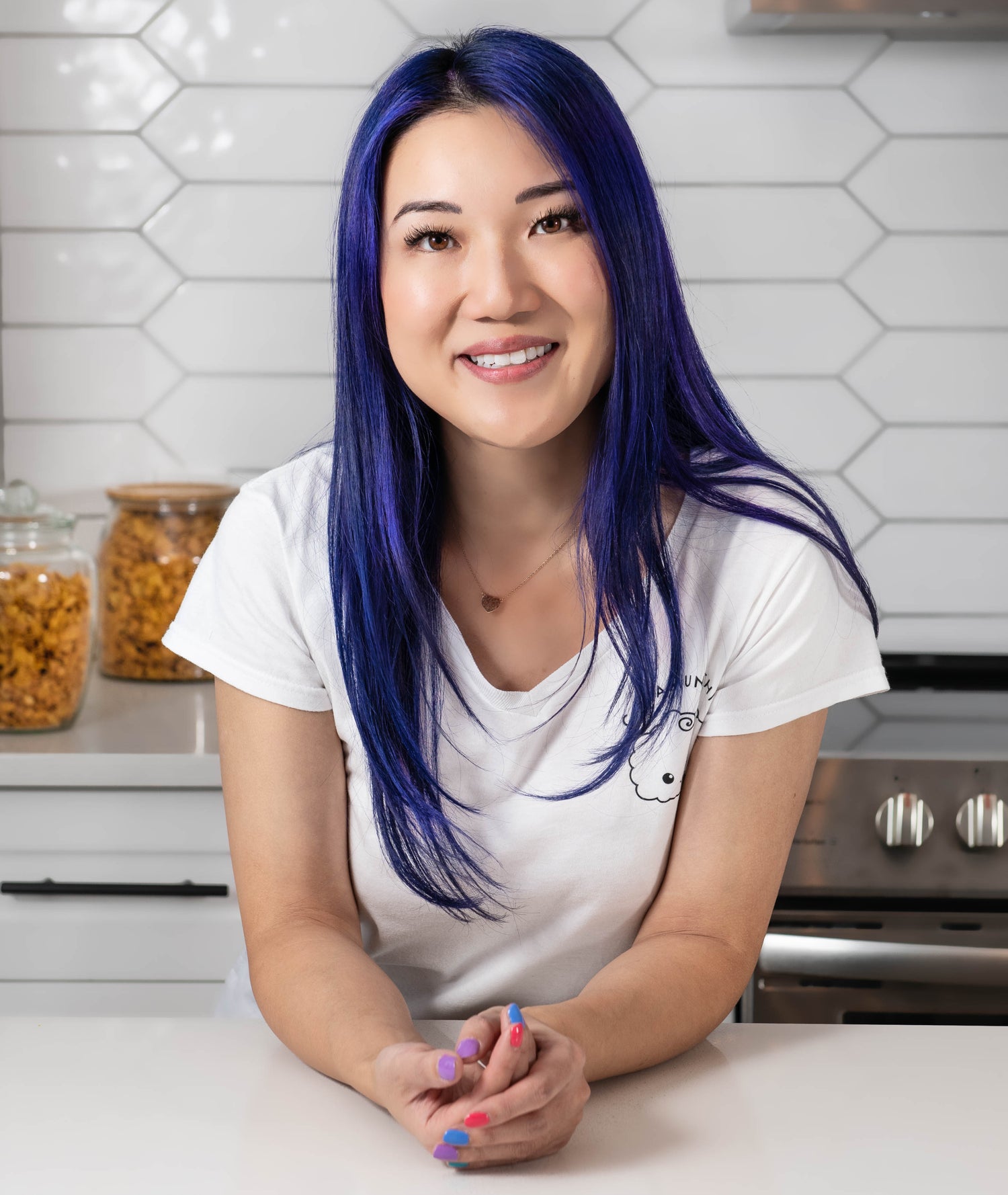 Alysia leaning into a countertop, smiling at the camera.