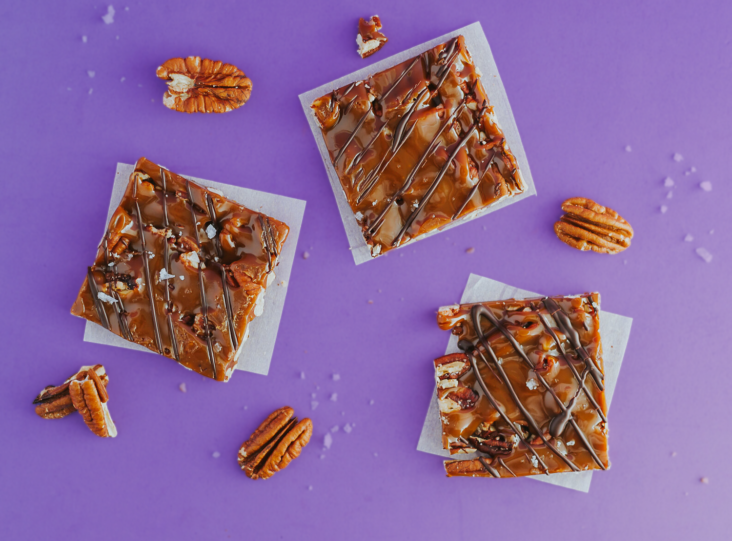 Caramunchies Pecan Squares close up on a purple background.