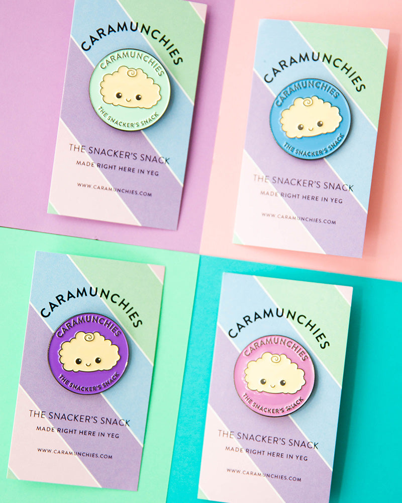 Four Caramunchies pins, in green, blue, purple and pink.
